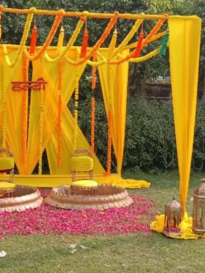 A classic and simple Haldi decor setup for an outdoor lawn. I used bright yellow drapes, marigold garlands, and elegant seating to create a traditional and auspicious space for the ceremony.