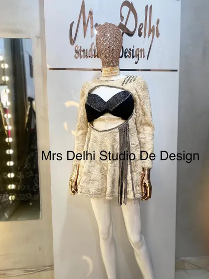 A unique customized winter dress. This piece features a cream-colored fur-like texture with a bold black bralette cutout, perfect for making a fashion statement.