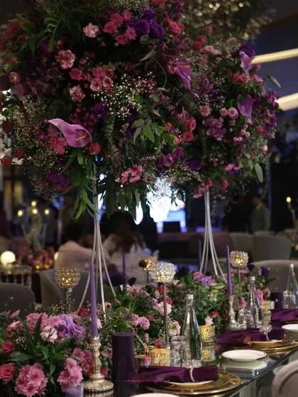 A tablescape that’s serving pure opulence. Deep purples, towering floral arrangements, and glowing crystal accents created a dining experience that felt both intimate and incredibly grand.
