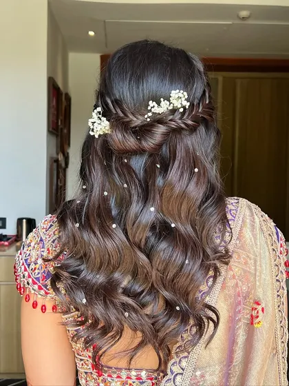 This hairstyle is a perfect blend of elegance and simplicity, ideal for a daytime Haldi ceremony.
