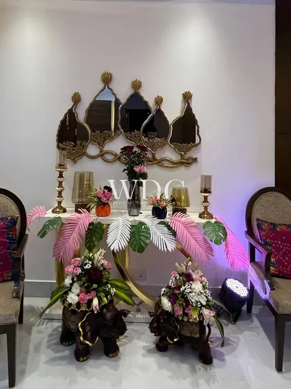An eclectic and artistic decor corner, featuring elephant-shaped floral holders, modern mirrors, and colorful cushions, showcasing our ability to mix and match different styles.