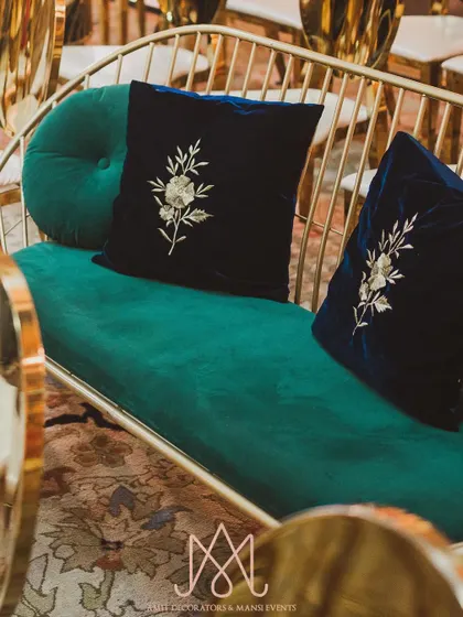 Custom designer pillows with delicate embroidery on rich velvet, used to tie in color accents and add a layer of luxury to the seating.