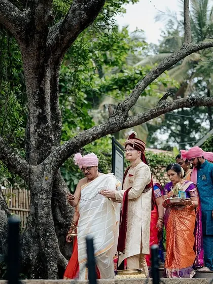 The groom's procession makes its way towards the ceremony area, a vibrant and traditional scene.