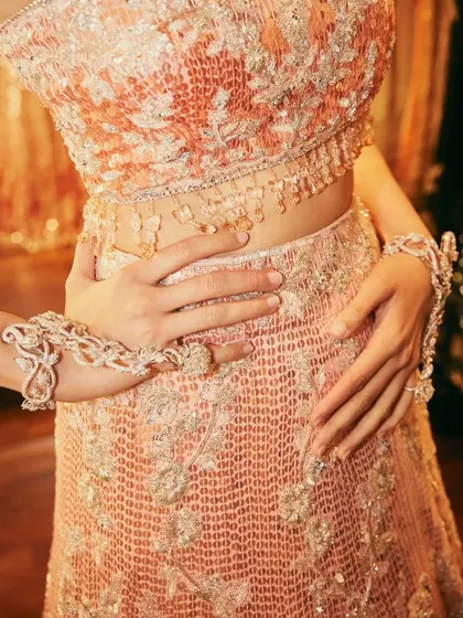 It's all in the details. A close-up of the intricate beadwork and hand jewelry that completed the Manish Malhotra sangeet ensemble.