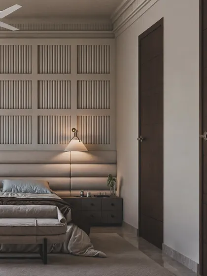 This view highlights the gridded, paneled wall behind the bed, adding a classic architectural detail to the modern space.