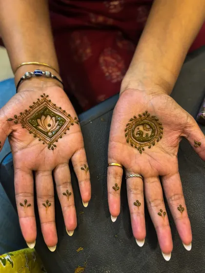 A creative and minimalist design for a guest, with a lotus in a diamond on one hand and an elephant in a circle on the other.