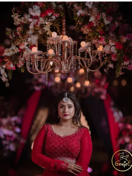 A striking portrait of the bride under a magnificent floral chandelier.