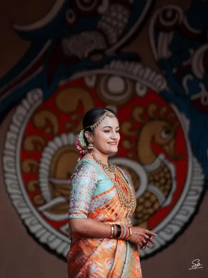 A candid side-profile of the bride against a traditional mural, blending modern portraiture with cultural art.