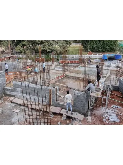 An overhead view of the Nandi Hills site, showing the layout of the granite off-cut walls and the steel reinforcement for the concrete structure.
