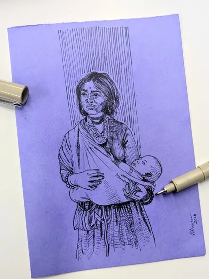 The "Amma" illustration shown flat with the micron pen used to create it. The vertical lines in the background add a stylistic element, suggesting rain or a divine presence.