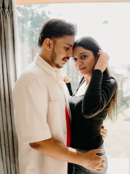 An intimate portrait by the window. The soft natural light and their close embrace create a warm, romantic, and timeless image.