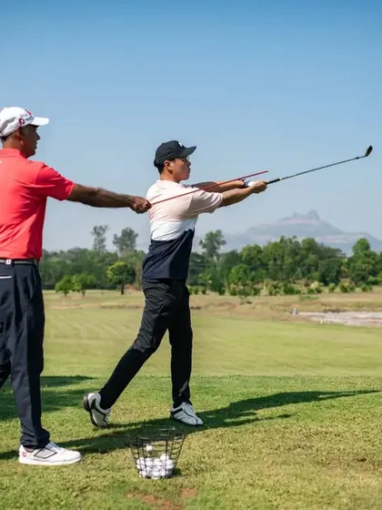 Here, we're guiding a student through the proper follow-through position. A complete and balanced finish is a key indicator of a well-executed golf swing.