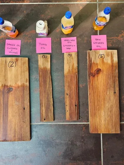 Testing different wood finishes is a crucial part of the restoration process. These samples show various oils and waxes being tested on reclaimed wood, a detail from our hands-on work at The Verdun House.