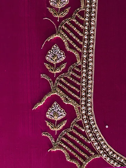 A detail of the zari and beadwork on a magenta blouse, showcasing the floral and traditional motifs that I love to incorporate into my designs.