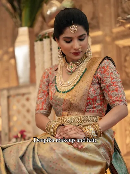 This look combines modern elegance with tradition, featuring a muted gold saree, layered pearl and emerald jewelry, and a sophisticated updo.