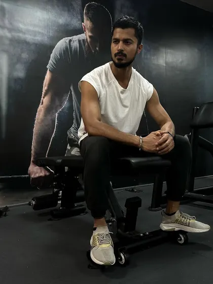 A quiet moment of reflection in the gym. Fitness is as much a mental journey as it is a physical one.