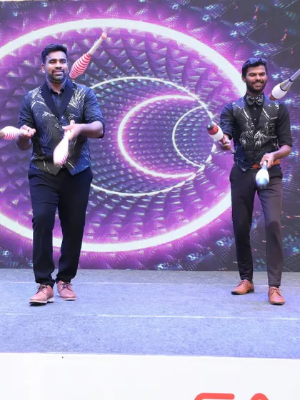 Our juggling duo performs a synchronized routine with clubs. This act requires immense precision and teamwork, making it a captivating performance for any stage.