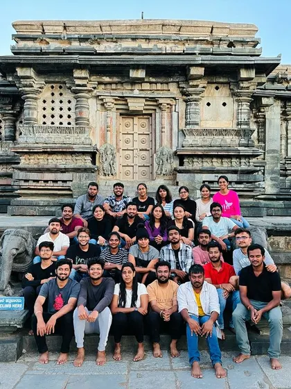 A large group photo at the magnificent Belur Temple, a cultural highlight of our Bandaje trek trip.