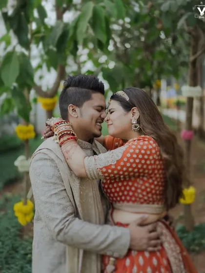 A happy, candid embrace between the bride and groom. Their genuine smiles and the natural setting create a portrait that feels warm, authentic, and full of love.