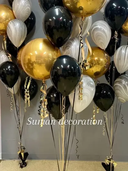 A sophisticated balloon bouquet with a black, gold, and marbled white color scheme. This is great for adult birthdays or corporate events.