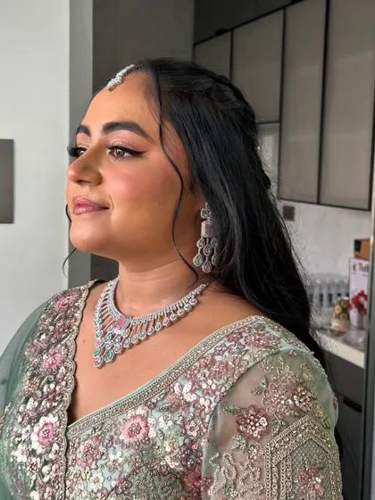 A side profile showing off her half-up hairstyle and glowing skin.