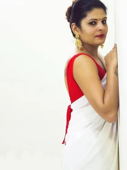 A simple yet bold look featuring a plain white saree with a striking red backless blouse. This shows how a custom blouse can be the hero of an outfit.