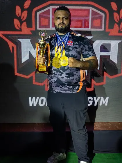 As a coach, their victory is my victory. Holding the team trophy and medals from the Hades MMA championship.