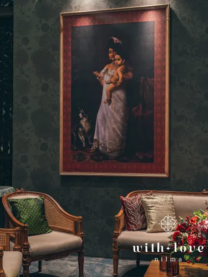 Another beautiful seating arrangement, where a Raja Ravi Varma painting of Yashoda and Krishna adds a touch of divine love and maternal warmth to the decor.