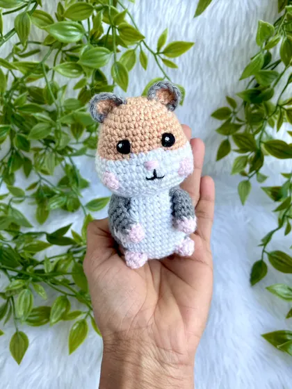 Holding the little hamster doll to show how perfectly he fits in your palm.