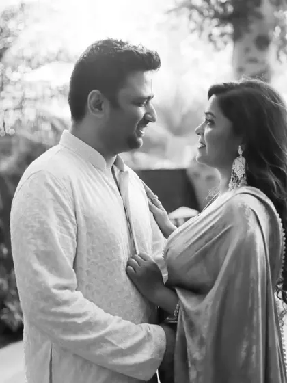 A beautiful black and white candid from a Roka ceremony. The couple is looking at each other with so much love and happiness.