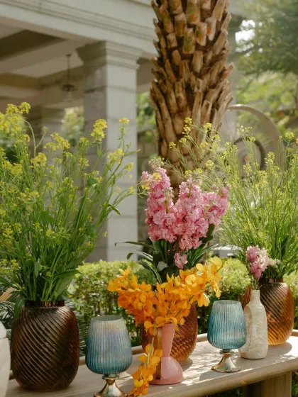 A detail from a personalized Mehendi, featuring colorful floral arrangements and unique glassware. Every element was chosen to reflect the couple's story.
