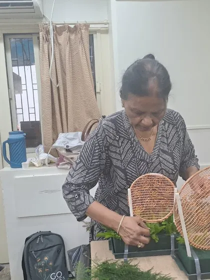 A student carefully places foliage into her arrangement during our special Diwali workshop. We love hosting festive sessions that teach practical skills for creating beautiful decorations for special occasions at home.