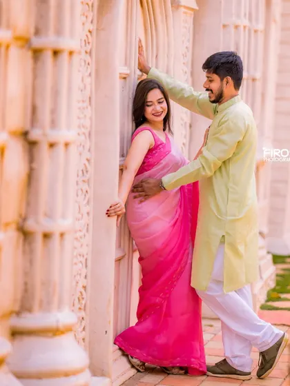 A tender, romantic moment in a sun-drenched corridor. The soft light and the couple's gentle embrace create a very warm and intimate photo.