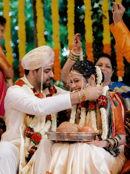 A beautiful candid moment from Anusha and Rohan's wedding ceremony, as the groom blesses the bride with sacred rice.