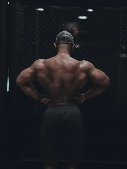 A rear lat spread pose. This demonstrates the width of the back, a key component in creating the classic V-taper physique.
