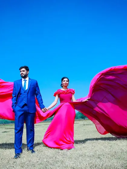 The full "flying" effect of the pink gown. I help style these shots on location to ensure the fabric catches the wind perfectly for a dramatic, wing-like appearance.