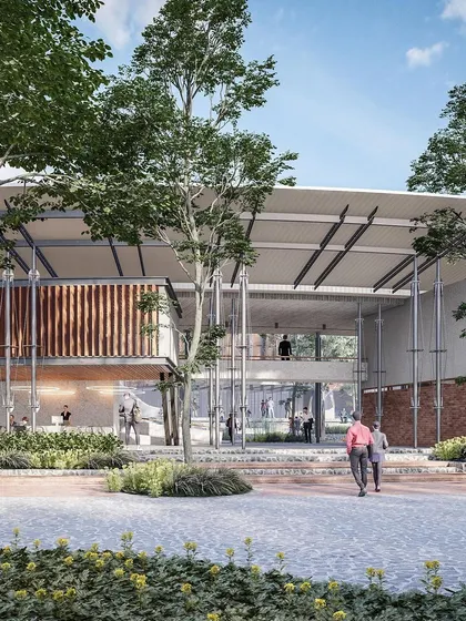 This render shows the main entrance of the Centre for Excellence, designed to be open and inviting. The use of tall columns and a high ceiling creates a grand yet accessible feel for visitors.