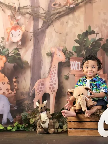 A happy smile from the birthday boy during his jungle-themed photoshoot. I love capturing these joyful moments as they celebrate their very first birthday.