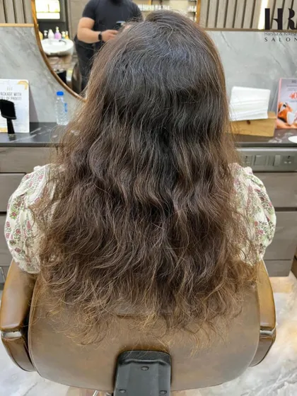Before her treatment, this client had wavy, frizzy hair that was difficult to manage.