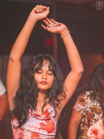 A guest dancing with her hands in the air at TYD.