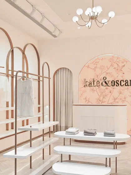 Another view of the boutique's interior, highlighting the modern globe chandelier and the soft, inviting glow of the space.