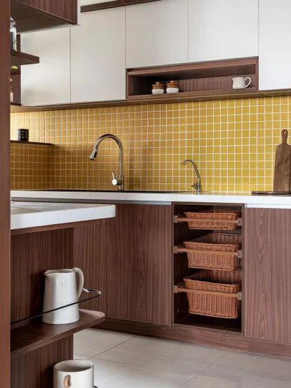 This kitchen from our 'Living Life in Colour' project features a popular combination of walnut-finish laminate and a warm yellow tile backsplash.