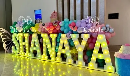 Large marquee letters spelling "SHANAYA" light up the entrance to her sweet Candyland-themed birthday party.