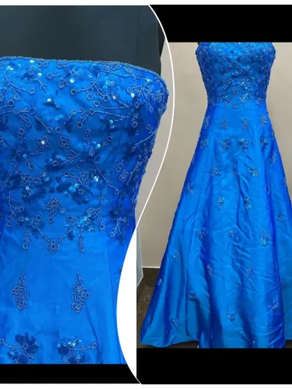 A classic strapless A-line gown in a vibrant royal blue. The bodice is covered in delicate, tone-on-tone sequin embroidery.