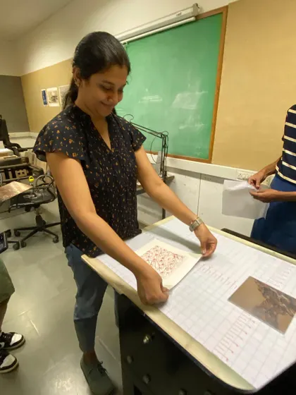 A student proudly displays her finished print. These moments of creation are what make teaching so rewarding, seeing an idea brought to life through a dedicated process.