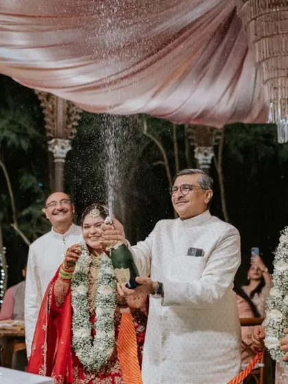 The reception is a time for celebration with loved ones. Here, Ridhi and Prashanth cut their cake, surrounded by the smiles and applause of their family and friends under a beautifully decorated canopy.