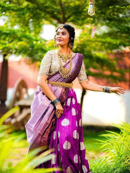 A side profile that gives a good look at the intricate hairstyle and the heavy temple jewellery.