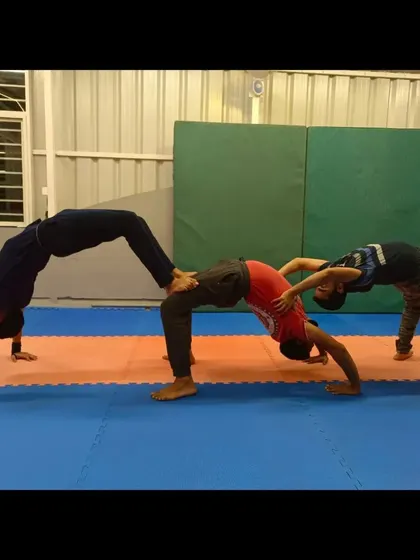 My students creating a "caterpillar" with their backbends. This is a fun, creative exercise that builds teamwork and core strength.