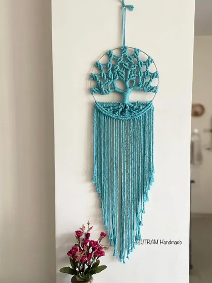 Here is a Tree of Life wall hanging in a lovely shade of sky blue. It looks so peaceful and is perfect for adding a touch of calm and boho style to your wall decor.