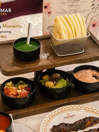 Savoring moments while capturing memories. Our vibrant Mezze Platter, with fresh pita, salads, and dips like hummus and mint chutney, offers a delightful taste of the Mediterranean.